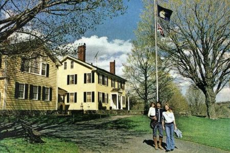 Charles Bronson in black holding his daughter alongside wife Jill Ireland in his farmhouse at Vermont.